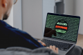 Laptop mit geöffneter E-Mail und einer Lupe daneben, Symbol für das Erkennen von gefälschten Buchungsanfragen bei Stadtführungen in Dresden